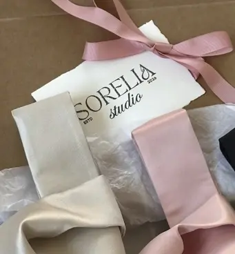 Sorelia studio card tied with a blush ribbon